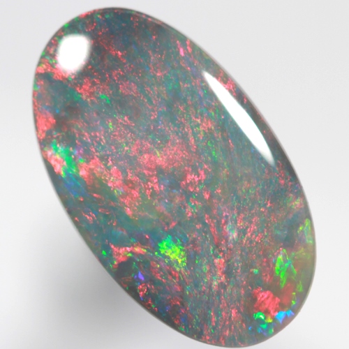 SOLID BLACK OPAL Bright red rolling flashes over green and blue sparkles SEE VIDEO